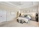 Bright main bedroom with tray ceiling, large windows, and neutral decor offers a serene and inviting space for relaxation at 12710 Stone Ridge Pl, Lakewood Ranch, FL 34202