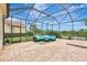 Screened-in patio with brick flooring features an outdoor seating area and a scenic lake view at 12710 Stone Ridge Pl, Lakewood Ranch, FL 34202