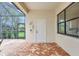 Covered patio featuring an outdoor shower and brick flooring at 12710 Stone Ridge Pl, Lakewood Ranch, FL 34202