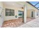 Covered patio with ceiling fan, brick flooring and backyard shower at 12710 Stone Ridge Pl, Lakewood Ranch, FL 34202