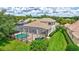 Aerial shot of a backyard featuring a screened-in pool area with a spacious deck and manicured lawn at 12710 Stone Ridge Pl, Lakewood Ranch, FL 34202
