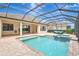 Relax by the pristine pool with a hot tub inside screened lanai and a lush backyard at 12710 Stone Ridge Pl, Lakewood Ranch, FL 34202