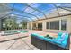 Covered patio featuring a pool, outdoor seating area, and brick flooring at 12710 Stone Ridge Pl, Lakewood Ranch, FL 34202