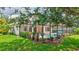 View of screened-in pool and patio surrounded by green landscaping and trees at 12710 Stone Ridge Pl, Lakewood Ranch, FL 34202