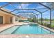 View of the pool, spa, and lanai with lake scenery from the outdoor area at 12710 Stone Ridge Pl, Lakewood Ranch, FL 34202