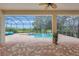 Screened-in pool and spa with serene lake views from the brick-paved patio at 12710 Stone Ridge Pl, Lakewood Ranch, FL 34202
