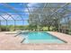 Pool with attached hot tub and brick deck inside screened lanai with lake views at 12710 Stone Ridge Pl, Lakewood Ranch, FL 34202
