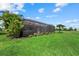 A spacious backyard features a screened-in patio and pool area, complimented by lush landscaping at 14216 Florida Rosemary Dr, Bradenton, FL 34211