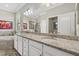 Bathroom boasts double sinks with granite countertops and a large mirror, offering ample space at 14216 Florida Rosemary Dr, Bradenton, FL 34211