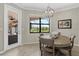 Cozy dining area features a wooden table, chairs, pendant lighting, and picturesque backyard views at 14216 Florida Rosemary Dr, Bradenton, FL 34211