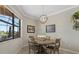 Inviting dining area showcases a round table, chair seating, pendant lighting and picturesque view of the backyard at 14216 Florida Rosemary Dr, Bradenton, FL 34211