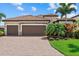 A beautiful single Gathering home with a paver driveway, two-car garage, and well-manicured landscaping at 14216 Florida Rosemary Dr, Bradenton, FL 34211