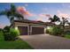 A well-kept single Gathering home with a brick paver driveway, two-car garage, and manicured landscaping at 14216 Florida Rosemary Dr, Bradenton, FL 34211