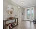 Elegant foyer with tiled floors, chandelier, and decorative table enhancing the home's welcoming atmosphere at 14216 Florida Rosemary Dr, Bradenton, FL 34211