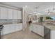 Well-appointed kitchen features ample white cabinetry, granite countertops, and stainless steel appliances at 14216 Florida Rosemary Dr, Bradenton, FL 34211