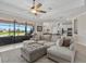 Open-concept living room with large sectional sofa, lake view, and seamless access to the kitchen at 14216 Florida Rosemary Dr, Bradenton, FL 34211