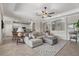 Cozy living space with neutral tones, plush sectional sofa, and open layout connecting to the modern kitchen at 14216 Florida Rosemary Dr, Bradenton, FL 34211