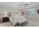 Main bedroom with neutral decor, tray ceiling, plantation shutters, and carpet flooring at 14216 Florida Rosemary Dr, Bradenton, FL 34211
