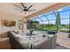 Relaxing screened patio with comfortable seating and a view of the pool and lake at 14216 Florida Rosemary Dr, Bradenton, FL 34211
