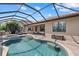 A gorgeous screened-in pool and spa featuring ample seating space and an outdoor lounge area at 14216 Florida Rosemary Dr, Bradenton, FL 34211