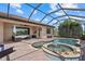 Stunning pool with spa and screened-in patio offers relaxation with beautiful outdoor views at 14216 Florida Rosemary Dr, Bradenton, FL 34211