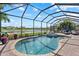 Beautiful pool and spa with screened-in patio overlooking the lake and well-manicured lawn at 14216 Florida Rosemary Dr, Bradenton, FL 34211
