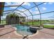 Sparkling pool and spa surrounded by lush landscaping and a screened enclosure at 14216 Florida Rosemary Dr, Bradenton, FL 34211