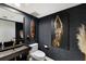 Chic powder room with unique sink, artistic decor, and stylish fixtures at 1445 Gulf Of Mexico Dr # 203, Longboat Key, FL 34228