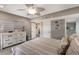 Comfortable bedroom with neutral tones, ceiling fan, dresser, and access to the bathroom and kitchen at 1445 Gulf Of Mexico Dr # 203, Longboat Key, FL 34228