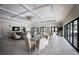 Elegant clubhouse featuring ample seating, a TV, neutral decor, pendant lighting, and large glass doors at 1445 Gulf Of Mexico Dr # 203, Longboat Key, FL 34228