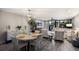 Inviting dining area with a round table, elegant chandelier, and wood-look floors at 1445 Gulf Of Mexico Dr # 203, Longboat Key, FL 34228