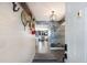 Inviting hallway with wood flooring, decorative wall hangings, and stylish lighting fixture at 1445 Gulf Of Mexico Dr # 203, Longboat Key, FL 34228