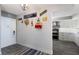 Stylish hallway with coastal decor, wood-look floors, and convenient access to the kitchen area at 1445 Gulf Of Mexico Dr # 203, Longboat Key, FL 34228