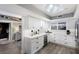 Well-lit kitchen featuring white cabinetry, stainless steel appliances, and a wine cooler at 1445 Gulf Of Mexico Dr # 203, Longboat Key, FL 34228