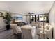 Comfortable living room with neutral tones, modern furniture, and sliding doors to a balcony at 1445 Gulf Of Mexico Dr # 203, Longboat Key, FL 34228