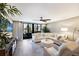 Bright living room with a ceiling fan, large windows, and a comfortable seating area at 1445 Gulf Of Mexico Dr # 203, Longboat Key, FL 34228
