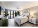 Serene main bedroom with a ceiling fan, balcony access, and neutral decor at 1445 Gulf Of Mexico Dr # 203, Longboat Key, FL 34228