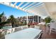 Relaxing covered patio featuring outdoor seating and views of the community at 1445 Gulf Of Mexico Dr # 203, Longboat Key, FL 34228