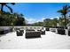 Spacious outdoor patio with comfortable seating, a grill, and lush landscaping, ideal for relaxation and entertaining at 1445 Gulf Of Mexico Dr # 203, Longboat Key, FL 34228
