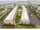 Aerial view of a waterfront condo complex with a pool, parking, and a nearby bridge to the ocean at 150 Harborside Ave # 307, Punta Gorda, FL 33950