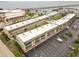 Aerial view showcases condo complex near bay, featuring ample parking and views at 150 Harborside Ave # 307, Punta Gorda, FL 33950