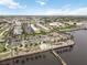 Aerial view showcases the waterfront restaurant with outdoor seating, close to the water, parking lot, and condos at 150 Harborside Ave # 307, Punta Gorda, FL 33950