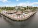 Overhead view of a waterfront bar and eatery with outdoor seating, surrounded by palm trees and water at 150 Harborside Ave # 307, Punta Gorda, FL 33950