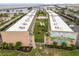 Aerial view featuring condo complex with mural, swimming pool, and lush landscaping at 150 Harborside Ave # 307, Punta Gorda, FL 33950