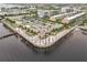 Aerial view of a waterfront restaurant with outdoor seating and palm trees at 150 Harborside Ave # 307, Punta Gorda, FL 33950