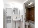 A pedestal sink, vanity cabinet, and fully tiled bathtub/shower define the details of this bathroom at 150 Harborside Ave # 307, Punta Gorda, FL 33950