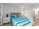 Cozy bedroom with a ceiling fan, closet, and a side table decorated with flowers at 150 Harborside Ave # 307, Punta Gorda, FL 33950