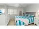 Well-lit bedroom with dresser, side table, ceiling fan, and natural light from the window at 150 Harborside Ave # 307, Punta Gorda, FL 33950