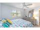 Bedroom with a ceiling fan, dresser with mirror, and a window providing natural light at 150 Harborside Ave # 307, Punta Gorda, FL 33950
