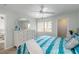 Bedroom featuring a dresser, mirror, and a window with a view to the outdoors at 150 Harborside Ave # 307, Punta Gorda, FL 33950
